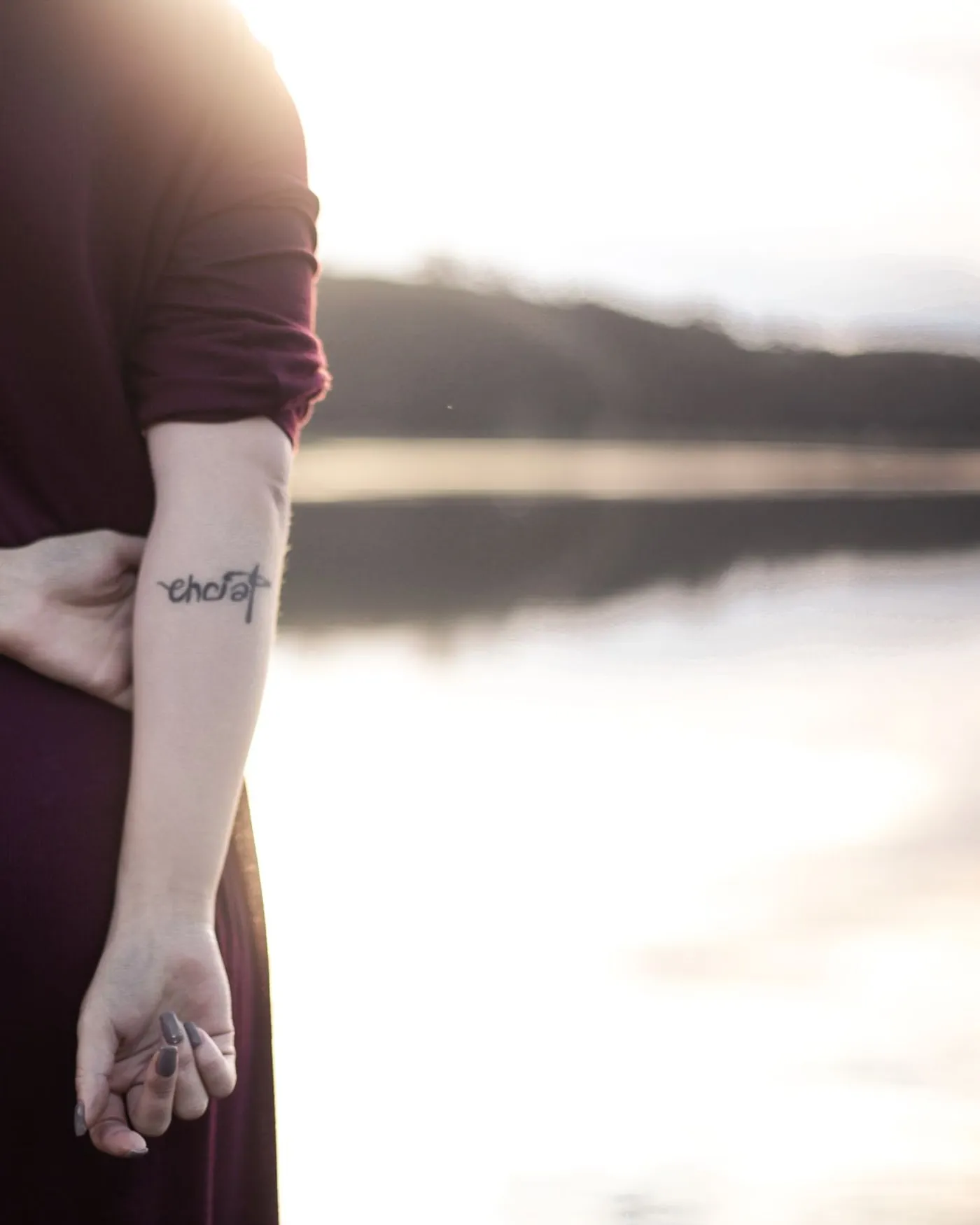 A line of fine script along the inner forearm, photographed on the day.